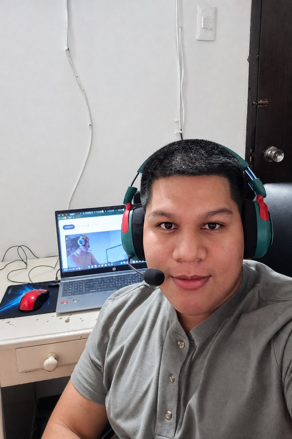 A Dealers in Drive collections specialist on a headset at a home desk